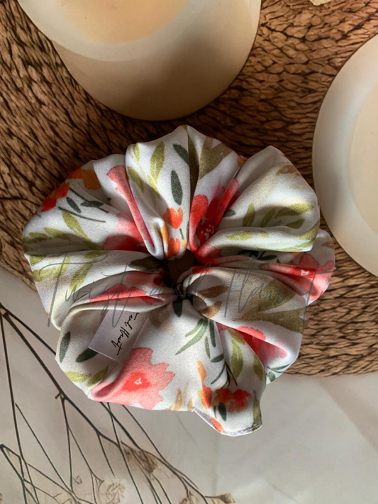 Twist and Flaunt - Floral patterned scrunchie on a textured surface